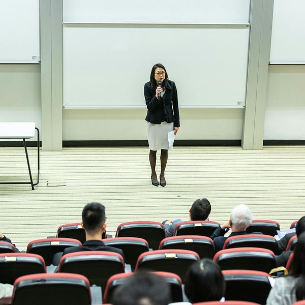 Corporate training workshop with instructor teaching ERP system
