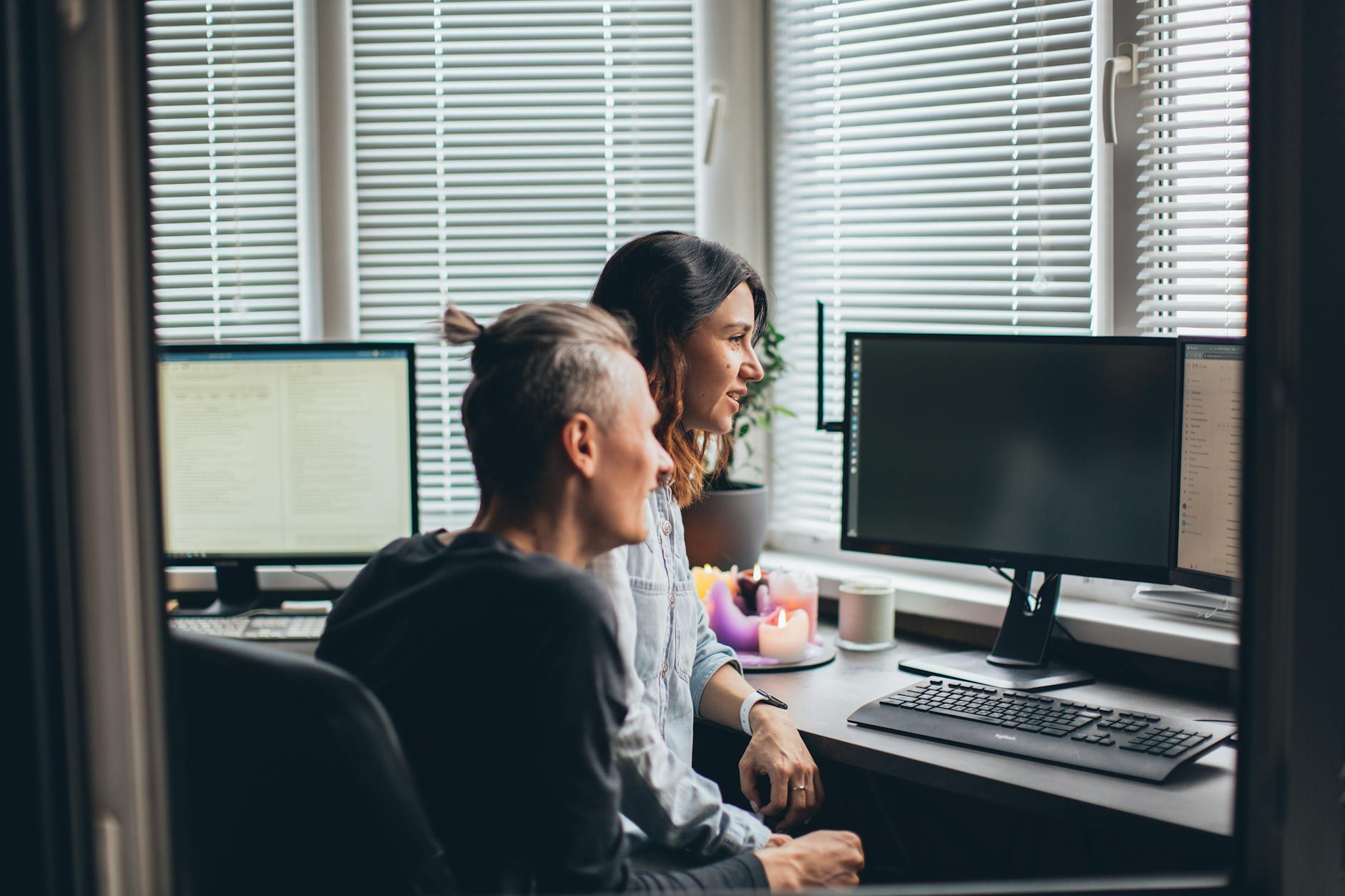 Modern office workspace with computers and collaboration area